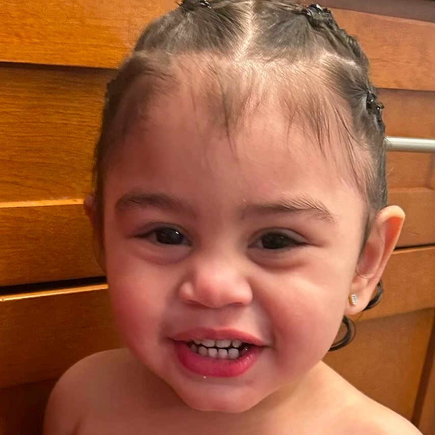Jael'Izahk joined the competition — help win amazing prizes! toddler, child, smiling, face, hair, braids, earrings, teeth, skin, portrait, indoor, cabinet, wood, happy, cute, person, baby, expression, closeup, head