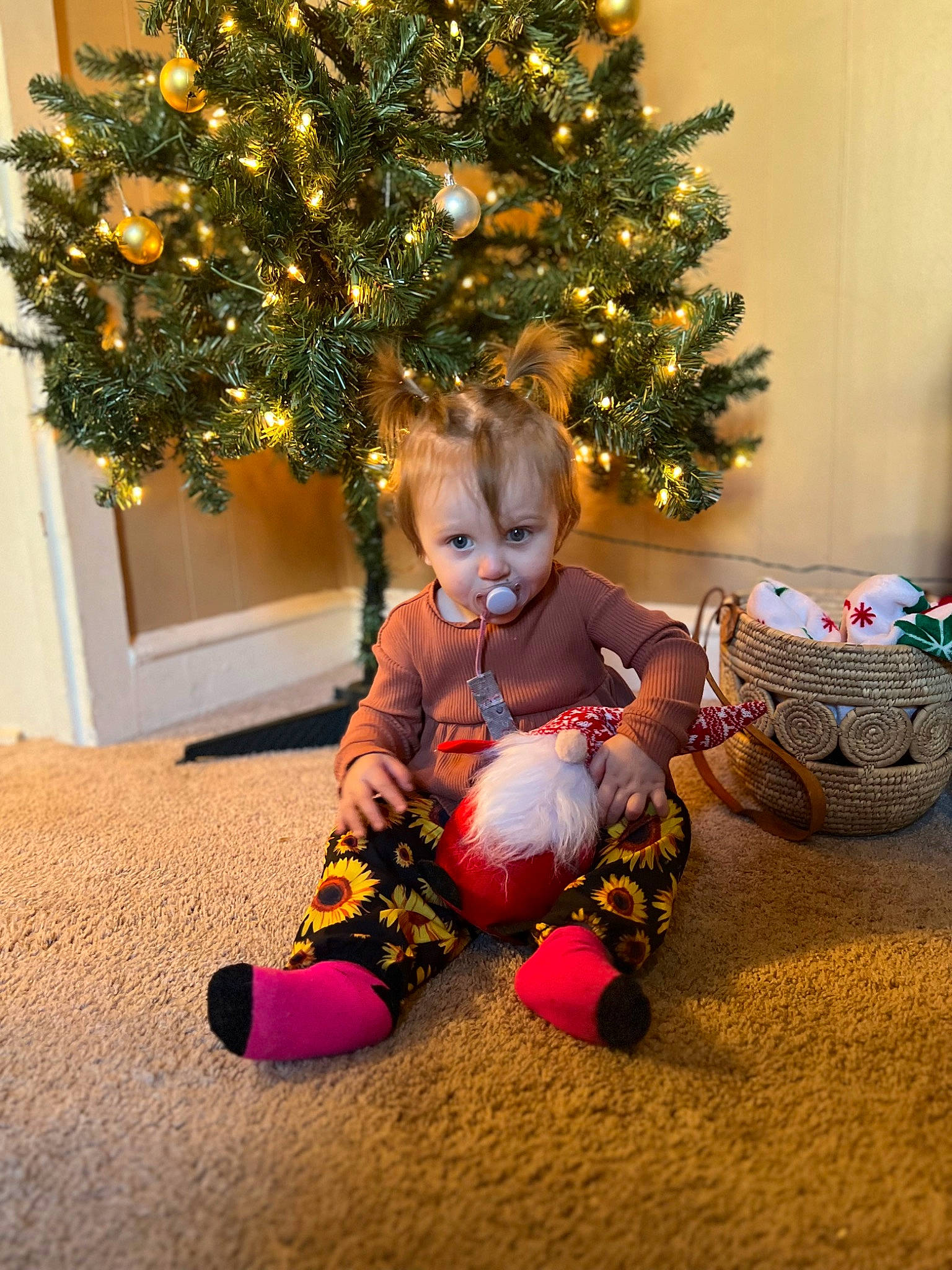 Kyla joined the competition — help win amazing prizes! baby, baby_toddler_clothing, christmas, christmas_decoration, christmas_ornament, christmas_tree, conifer, event, flooring, happy, holiday, holiday_ornament, interior_design, lap, ornament, person, plant, room, sitting, toddler