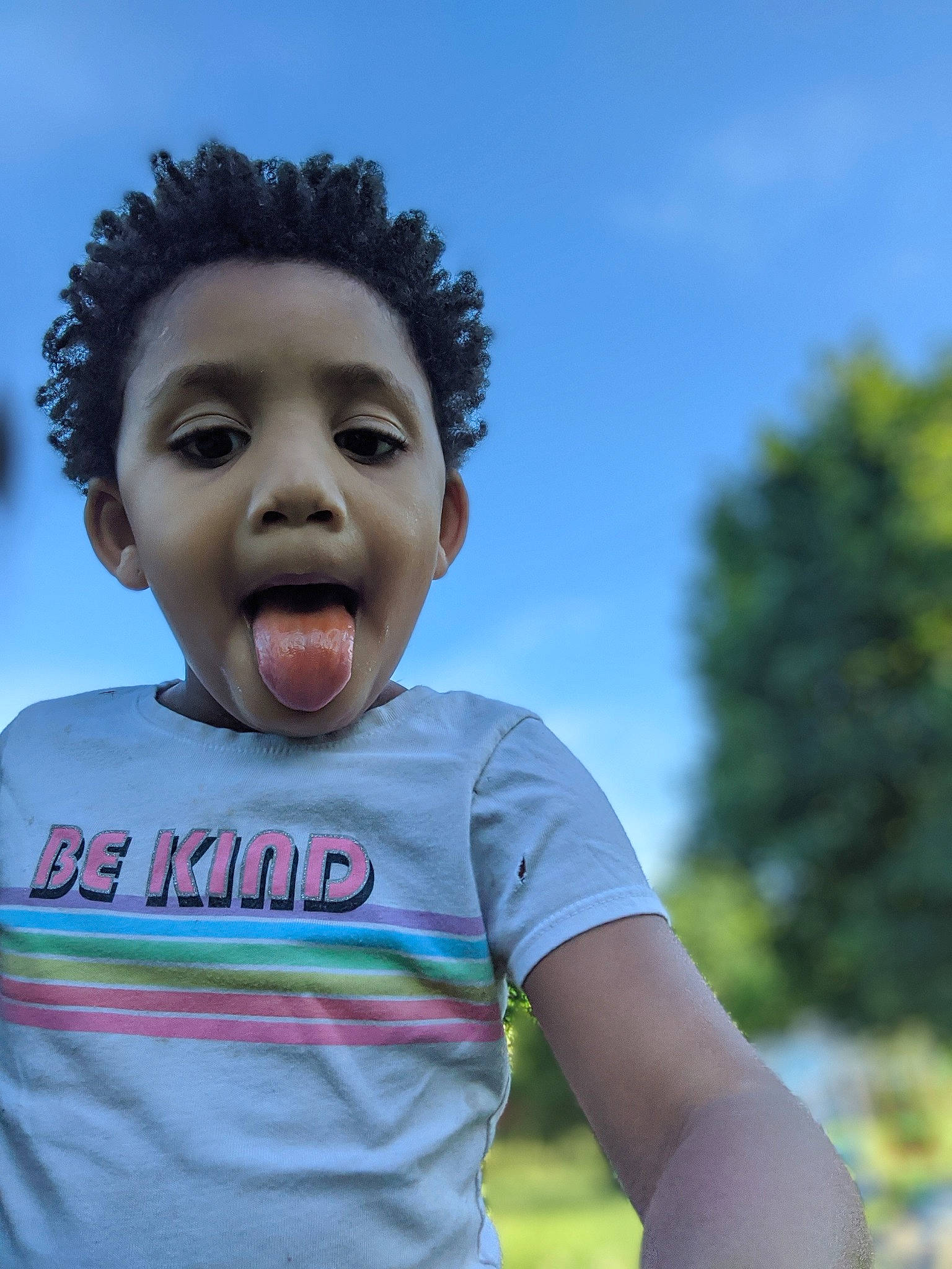 Aviana joined the competition — help win amazing prizes! afro, child, cloud, flash_photography, fun, gesture, grass, grassland, happy, human_body, laugh, leisure, nose, people_in_nature, person, portrait_photography, sky, smile, surprise, t_shirt