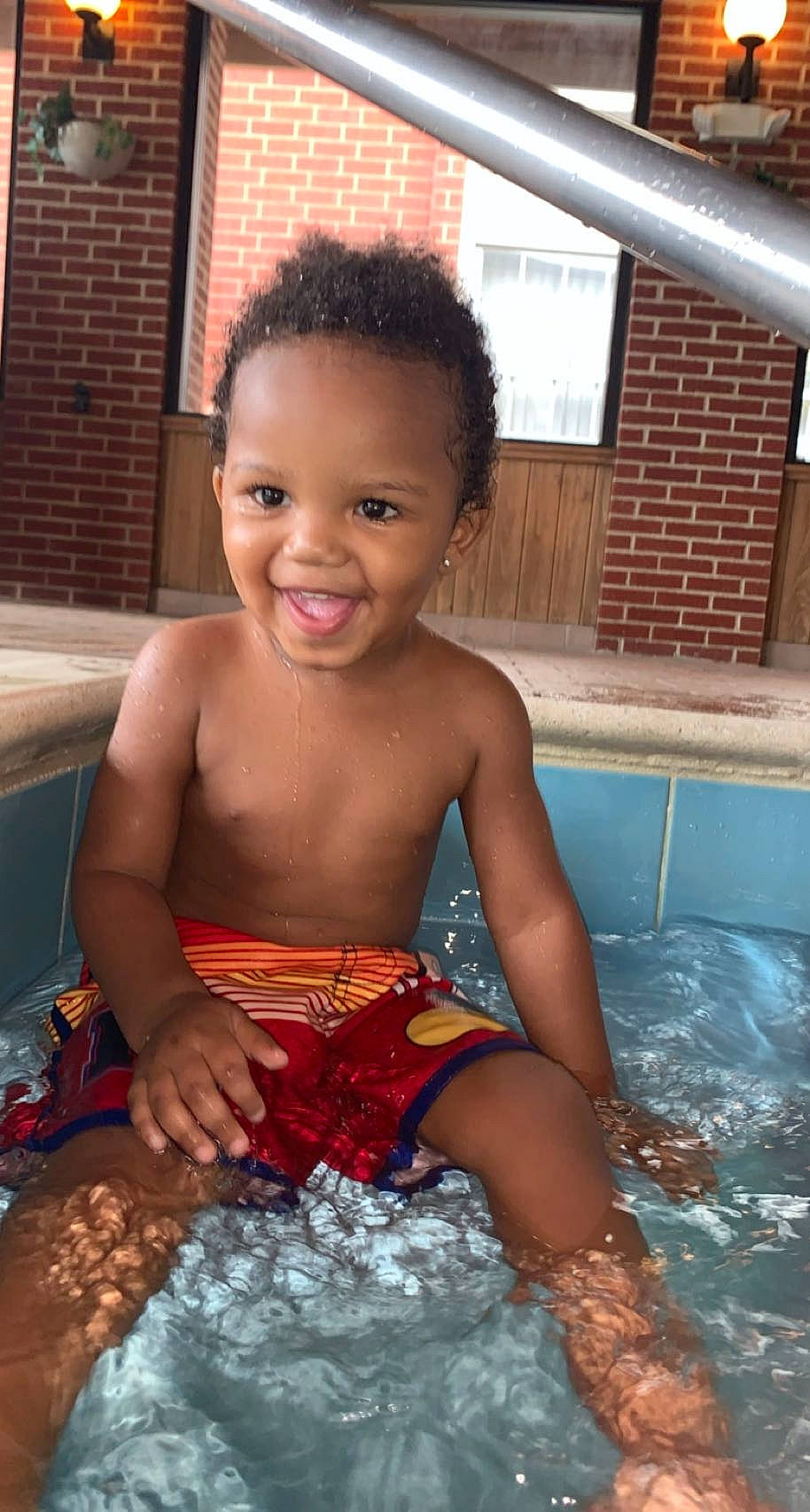 Kay'Vion is registered to the contest to win money with this photo: barechested, barefoot, bathing, black, chest, child, facial_expression, fun, happy, joy, leisure, muscle, people, person, recreation, sitting, smile, summer, swimming_pool, toddler