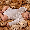 baby, sleeping, teddy_bears, plush_toys, white_onesie, cozy, cute, soft_texture, child, infant, resting, adorable, cuddly, background, brown, beige, toy_collection, peaceful, portrait, lying_down