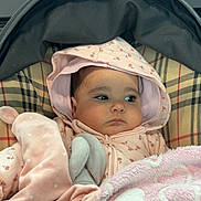 Ghosoul participe au concours pour gagner de l'argent avec cette photo : baby, blanket, child, clothing, comfort, cozy, cute, face, hood, indoors, infant, pink, plaid, portrait, resting, serious, soft, stroller, toy, warm