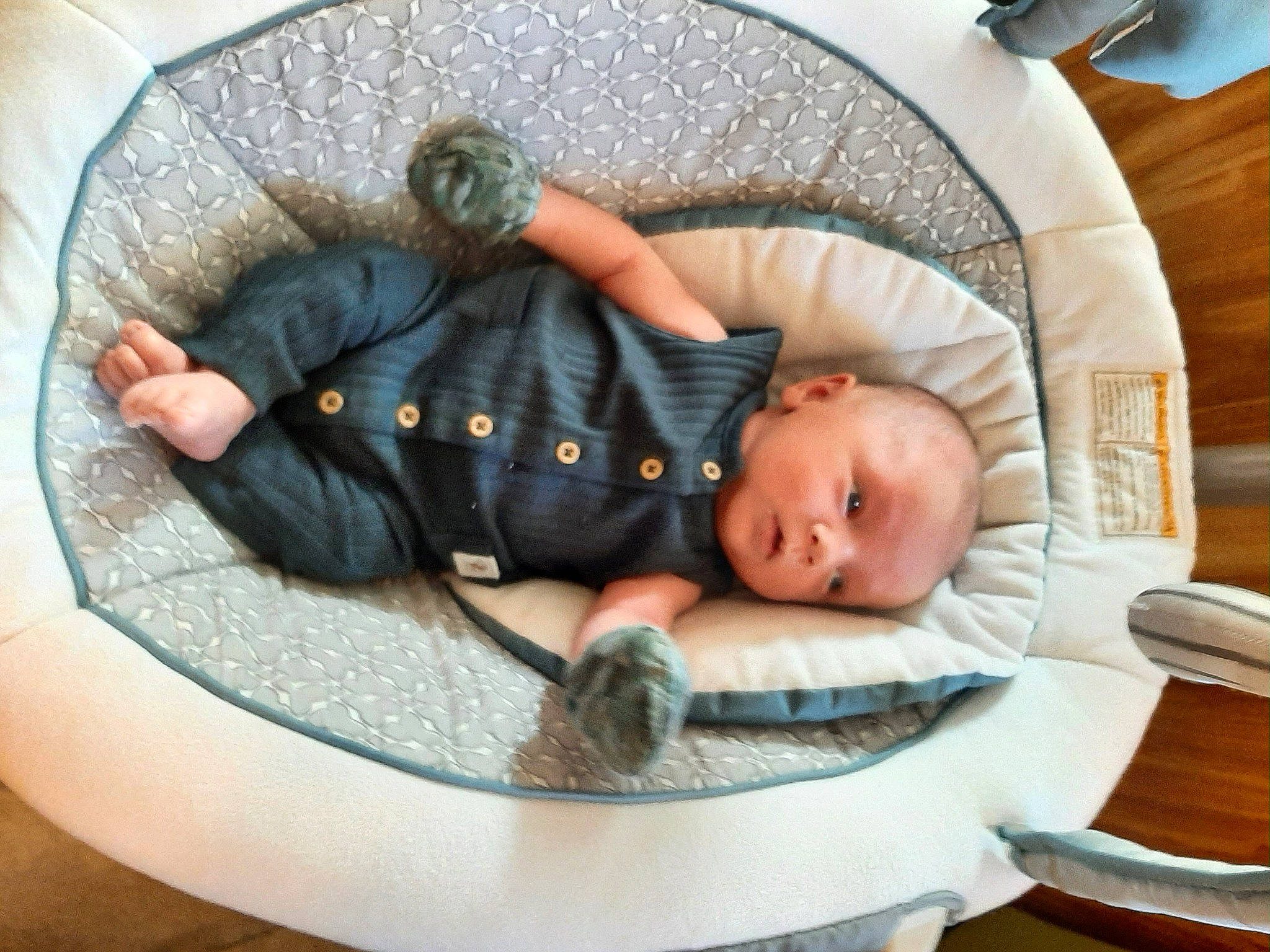 Crew is registered to the contest to win money with this photo: baby, baby_carriage, baby_products, baby_safety, baby_sleeping, baby_toddler_clothing, baby_toys, chair, child, circle, comfort, flooring, infant_bed, linens, person, room, sitting, toddler, wood