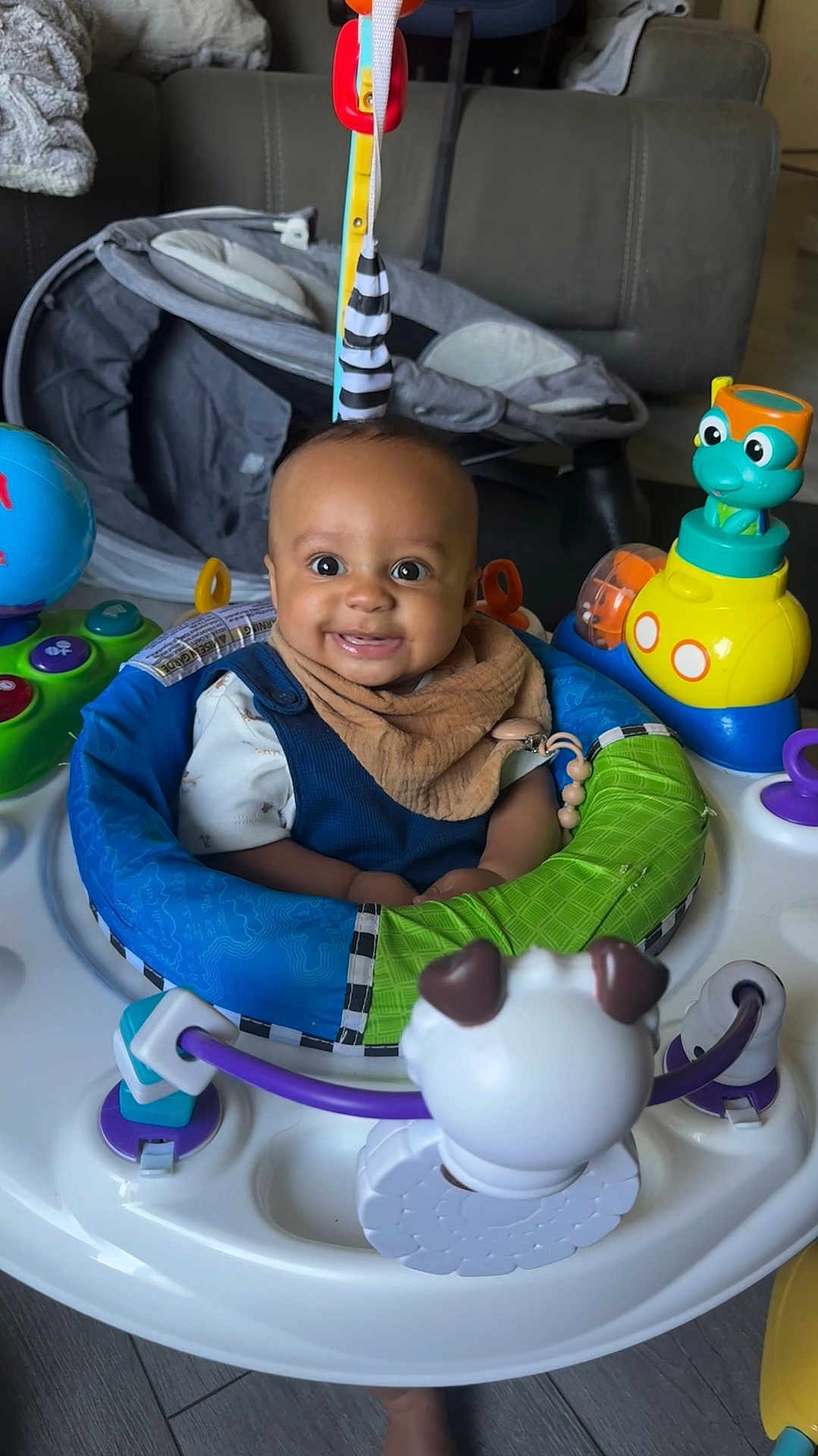 Zion joined the competition — help win amazing prizes! activity_center, baby, blue, child, clothing, colorful, face, floor, green, happy, head, indoor, infant, orange, person, play, seat, smiling, toy, yellow