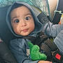 baby, child, car_seat, hoodie, plush_toy, seatbelt, indoor, cute, infant, clothing, person, closeup, sitting, expression, hand, soft_toy, safety, car_interior, young_child, portrait