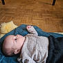 Ari participe au concours pour gagner de l'argent avec cette photo : baby, blanket, bodypart, clothing, couch, face, finger, furniture, hardwood, head, hosiery, knitwear, newborn, pants, person, photography, portrait, sock, sweater, wood