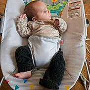 Ari participe au concours pour gagner de l'argent avec cette photo : baby, bed, bodypart, clothing, crib, cushion, cutlery, face, finger, furniture, hand, head, homedecor, infantbed, knitwear, pants, person, photography, portrait, sweater
