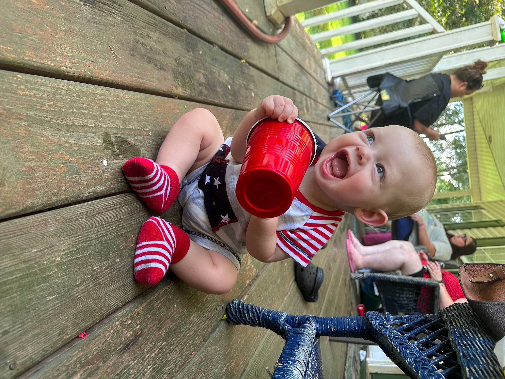 Jett is registered to the contest to win money with this photo: amusement_ride, baby, carmine, child, event, fun, grass, happy, human_leg, leisure, person, play, recreation, sandal, sitting, smile, toddler, toy, wood