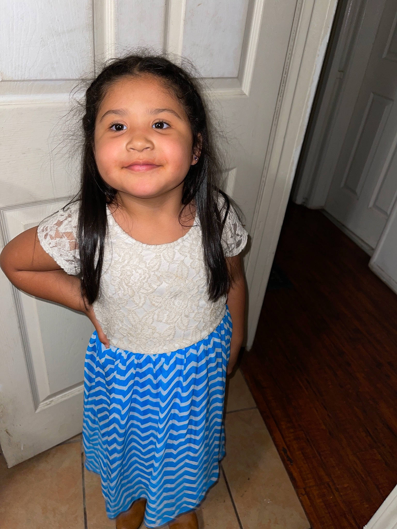 Sophia is registered to the contest to win money with this photo: arm, baby_toddler_clothing, clothing, door, dress, eye, face, floor, flooring, hair, happy, head, human_body, joy, neck, person, shoulder, skin, sleeve, smile