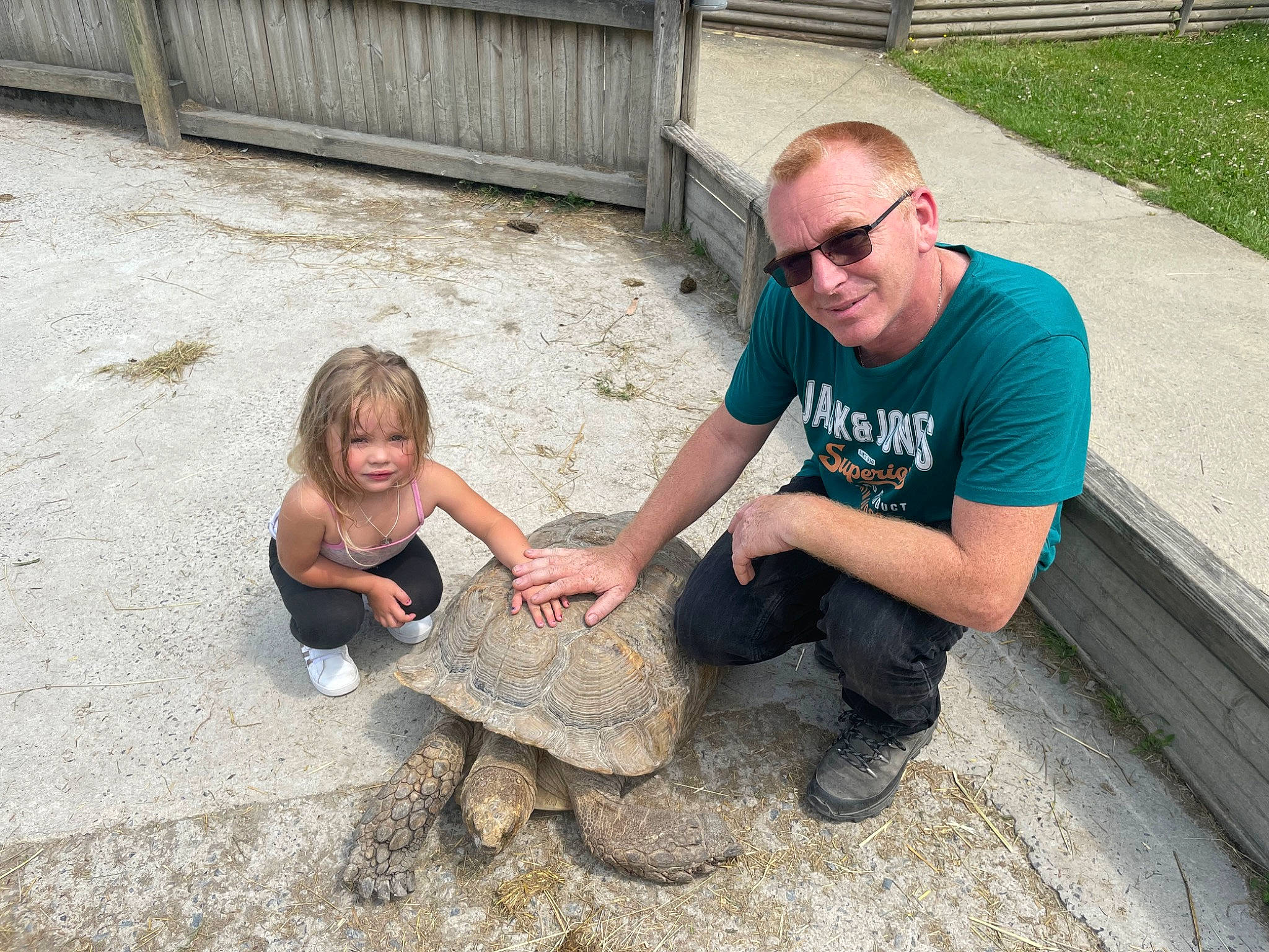 Liya participe au concours pour gagner de l'argent avec cette photo : asphalt, boot, child, concrete, event, eyewear, fun, grass, hand, joy, landscape, leg, leisure, mouth, person, recreation, sandal, sidewalk, sitting, smile