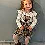 Lyza a rejoint le concours — aidez-le/la à gagner de superbes lots ! child, girl, standing, white_top, heart_design, plaid_skirt, tights, brown_boots, wet_hair, indoor, wall, tile_floor, smile, pose, young, fashion, clothing, cute, person, portrait