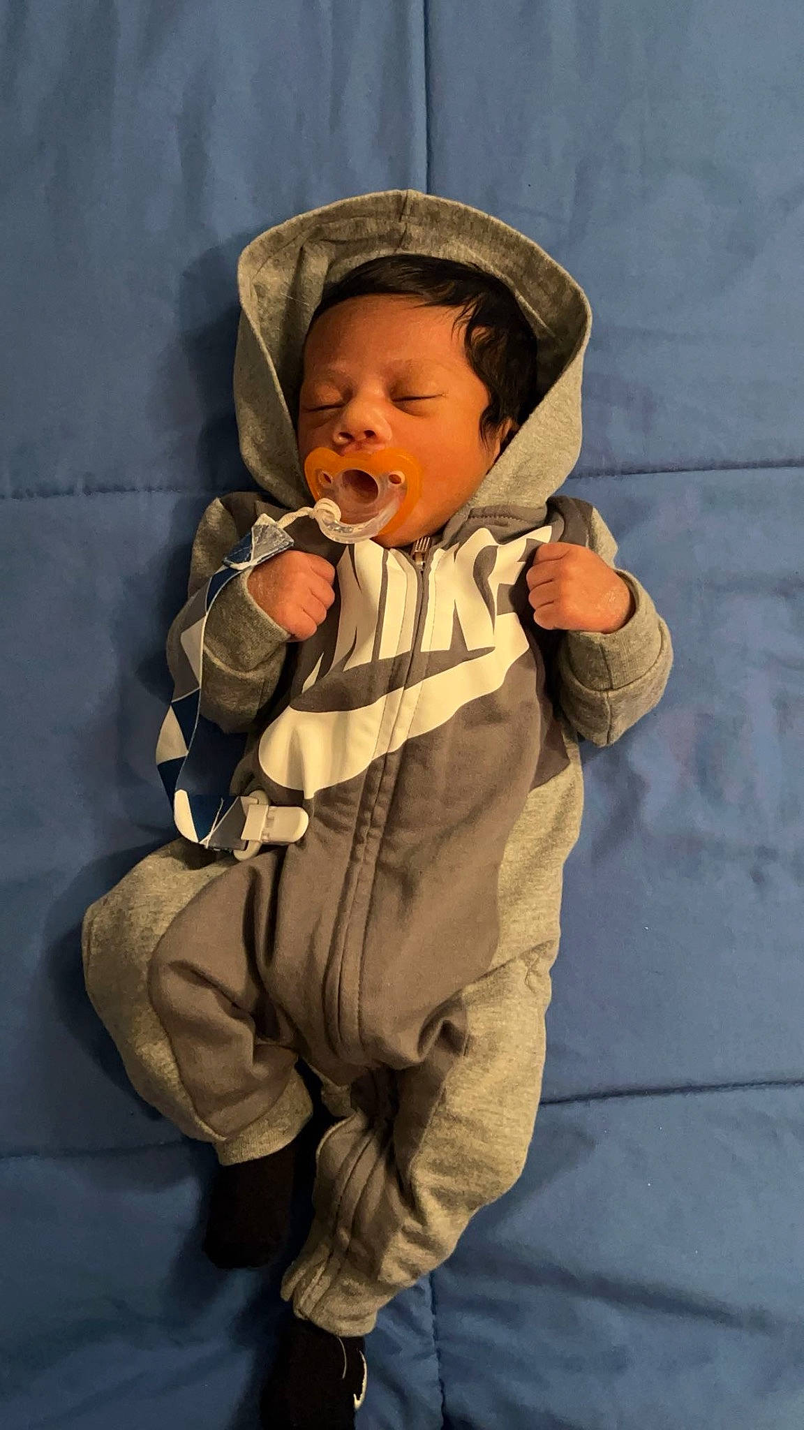 Zayden is registered to the contest to win money with this photo: baby, baby_toddler_clothing, camouflage, cap, cheek, comfort, eye, face, fashion_accessory, gesture, glove, hat, human_body, jacket, person, personal_protective_equipment, sitting, sleeve, thumb, toddler