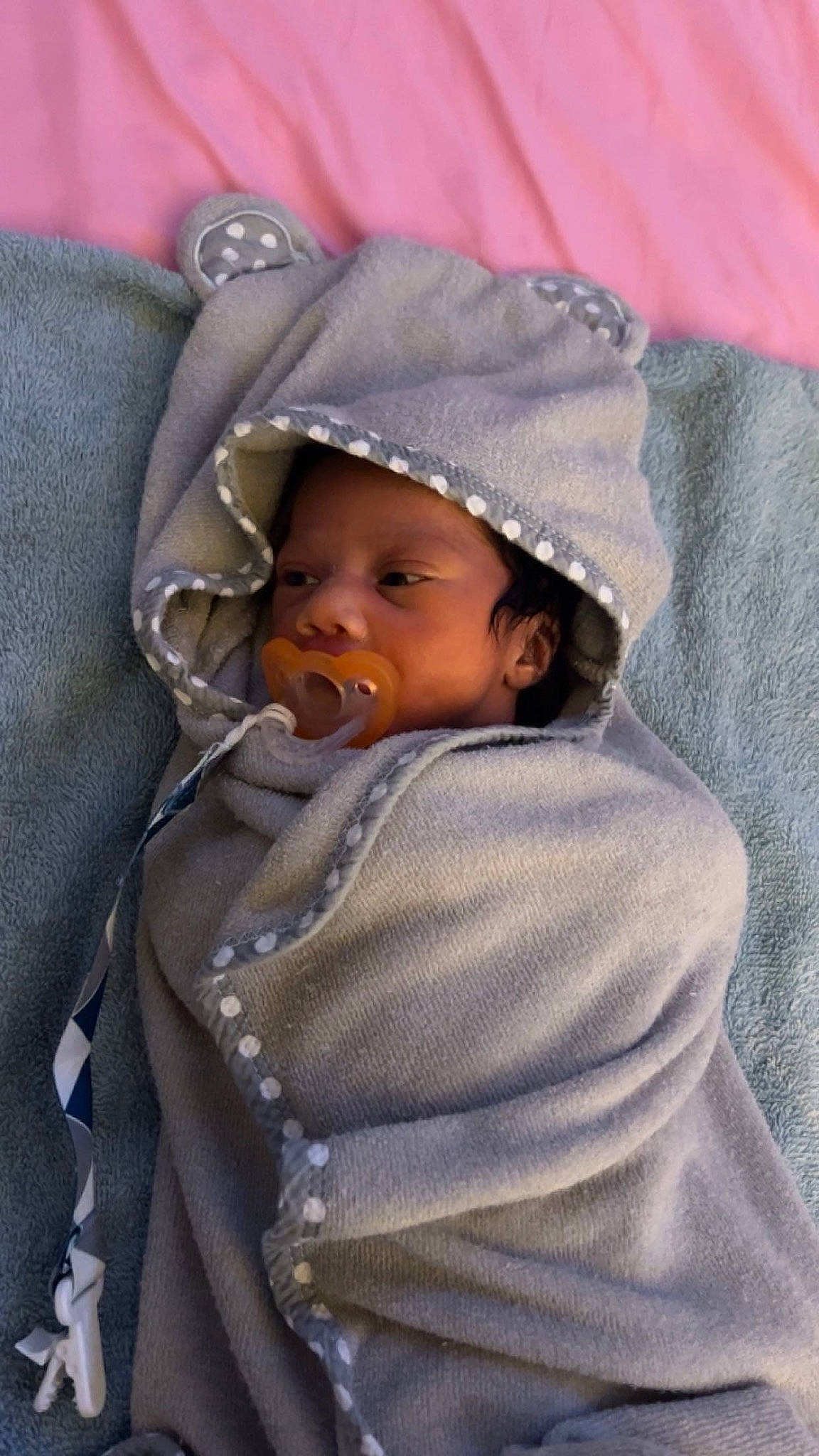 Zayden is registered to the contest to win money with this photo: baby, baby_carriage, baby_products, baby_toddler_clothing, cap, cheek, child, comfort, hat, headwear, hoodie, human_body, linens, lip, person, sitting, skin, sleeve, textile, toddler