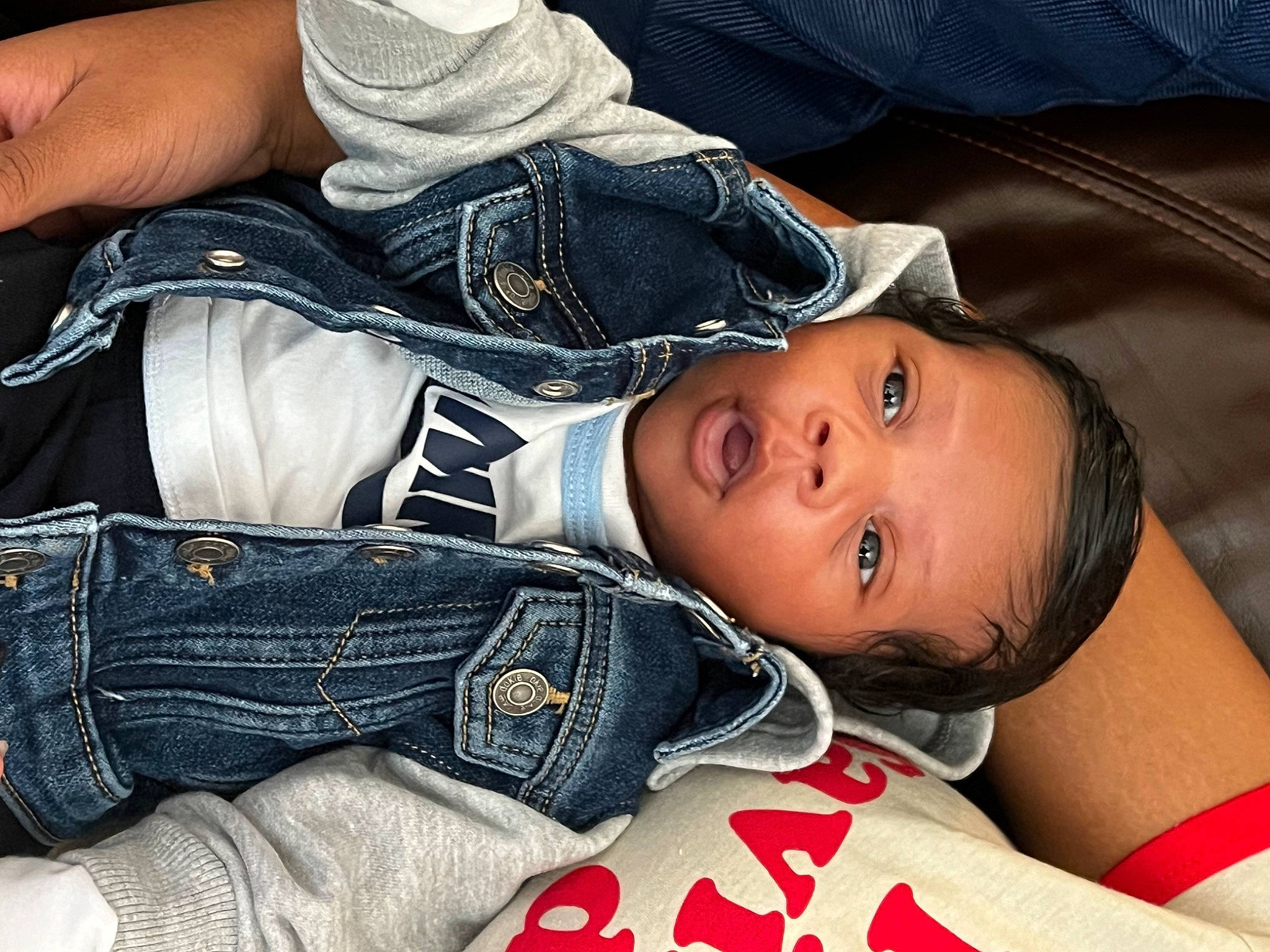 Zayden is registered to the contest to win money with this photo: abdomen, chest, child, comfort, cool, denim, elbow, finger, gesture, human_leg, joint, linens, pattern, person, plaid, portrait_photography, sitting, sleeve, thigh, toddler