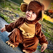 Milan joined the competition — help win amazing prizes! toddler, child, costume, monkey_costume, cute, outdoor, sidewalk, curious, brown, plush, clothing, face, eyes, expression, nature, grass, daylight, portrait, funny, baby