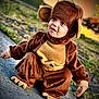 toddler, child, costume, monkey_costume, cute, outdoor, sidewalk, curious, brown, plush, clothing, face, eyes, expression, nature, grass, daylight, portrait, funny, baby