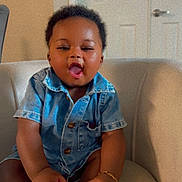 Joseph Fotsing joined the competition — help win amazing prizes! baby, child, denim_shirt, shoe, sitting, indoor, chair, happy, cute, toddler, person, smiling, short_hair, bracelet, footwear, home, casual_clothing, expression, skin, furniture