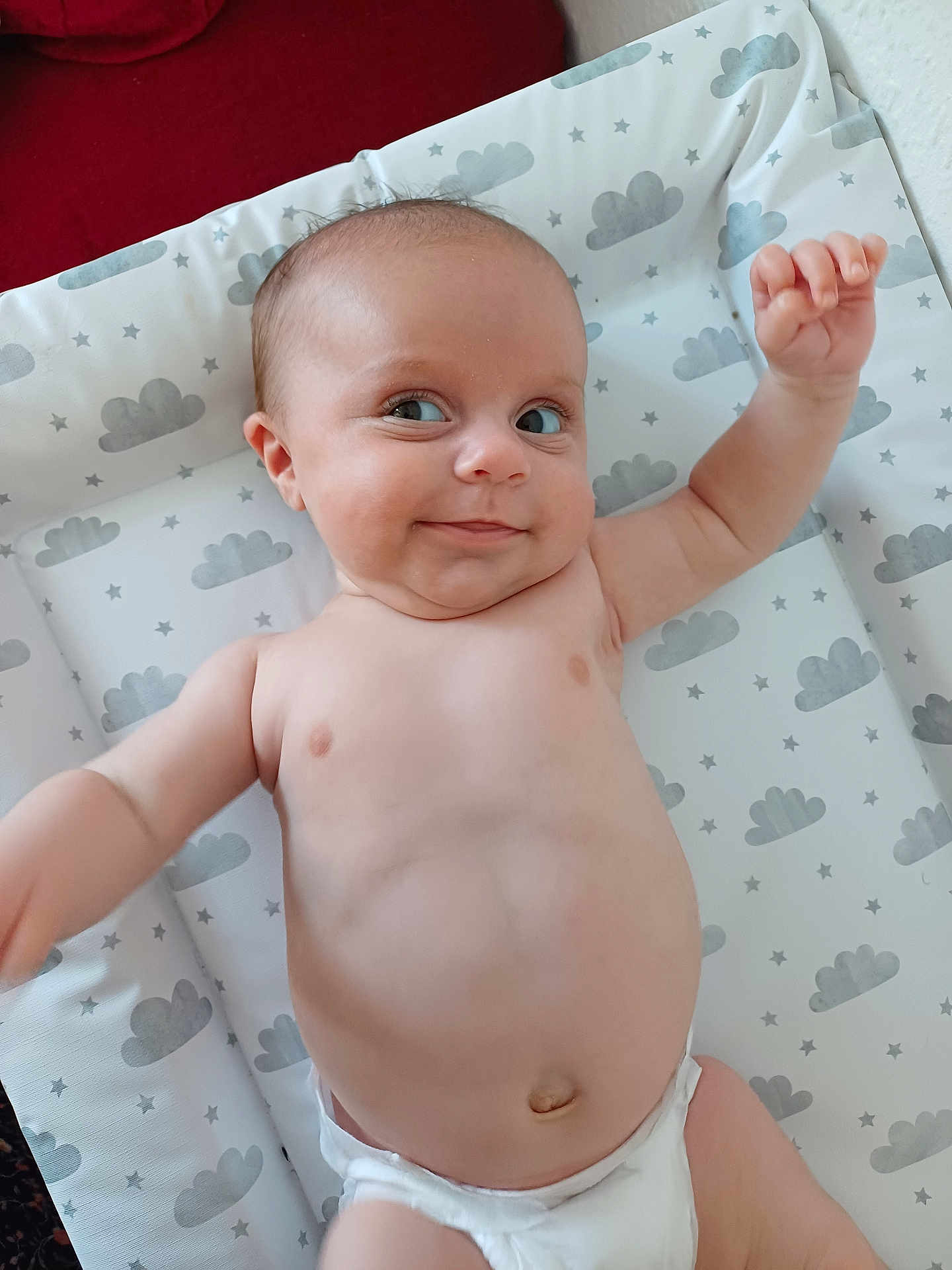 Charley joined the competition — help win amazing prizes! baby, infant, diaper, smile, face, arm, skin, changing_pad, cloud_pattern, stars, lying_down, cute, chubby, expression, indoor, child, person, human, playful, happy