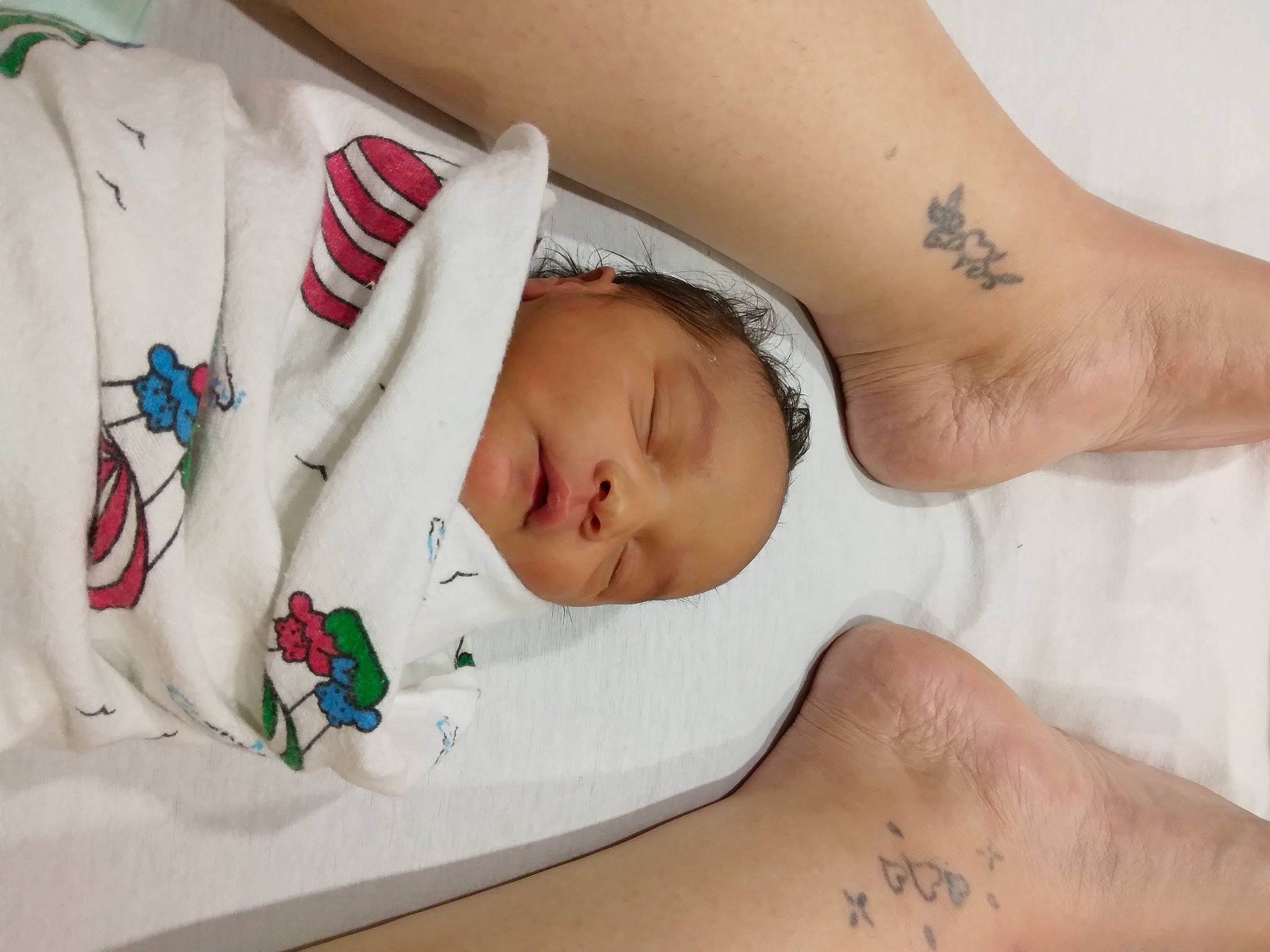 Isiah is registered to the contest to win money with this photo: abdomen, baby, baby_sleeping, baby_toddler_clothing, chest, child, comfort, elbow, foot, human_body, human_leg, joint, leg, linens, pattern, person, skin, stomach, thigh, toddler