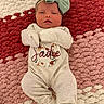 baby, bow, child, clothing, cozy, cream, cute, headband, indoors, infant, lying_down, newborn, pattern, pink, portrait, red, rug, sleeping, soft, textile
