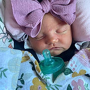 Sadie joined the competition — help win amazing prizes! baby, blanket, bow, child, cute, face, floral_pattern, green, headwear, indoors, infant, newborn, pacifier, peaceful, pink, purple, resting, sleeping, soft, swaddled