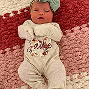 Sadie joined the competition — help win amazing prizes! newborn, baby, infant, onesie, headband, bow, blanket, pattern, texture, lying_down, sleeping, cute, cozy, child, face, clothing, soft_lighting, indoors, portrait, peaceful