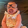 Sadie joined the competition — help win amazing prizes! baby, infant, child, portrait, sitting, pacifier, glasses, oversized_glasses, floral_outfit, dress, patterned_clothing, smiling, face, eyes, indoor, chair, close_up, funny, adorable, photography