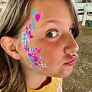 Peyton joined the competition — help win amazing prizes! child, face_paint, heart, flower, portrait, yellow_shirt, silly_face, outdoor, brown_hair, playful, close_up, expression, skin, person, head, ear, eye, nose, lips, dirt_ground