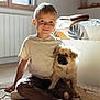 child, boy, puppy, dog, indoor, sunlight, window, rug, bed, blanket, smile, casual_clothing, socks, floor, cozy, cute, pet, home, portrait, happy
