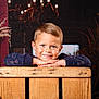 background, barn, blue_eyes, boy, casual_clothing, child, cozy, cute, dried_plants, face, hands, happy, indoor, lighting, portrait, rustic, smile, wood, wooden_crate, young