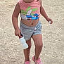 child, toddler, outdoor, walking, water_bottle, pink_shoes, tank_top, shorts, dirt_path, ground, daylight, casual_clothing, young_child, person, bare_legs, summer_clothes, playful, nature, active, cute