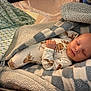 Ryder is registered to the contest to win money with this photo: animal_print, baby, bed, blanket, checkered, child, comfort, cozy, cute, indoor, infant, newborn, pajamas, pattern, peaceful, resting, sleeping, soft, warm, wrapped
