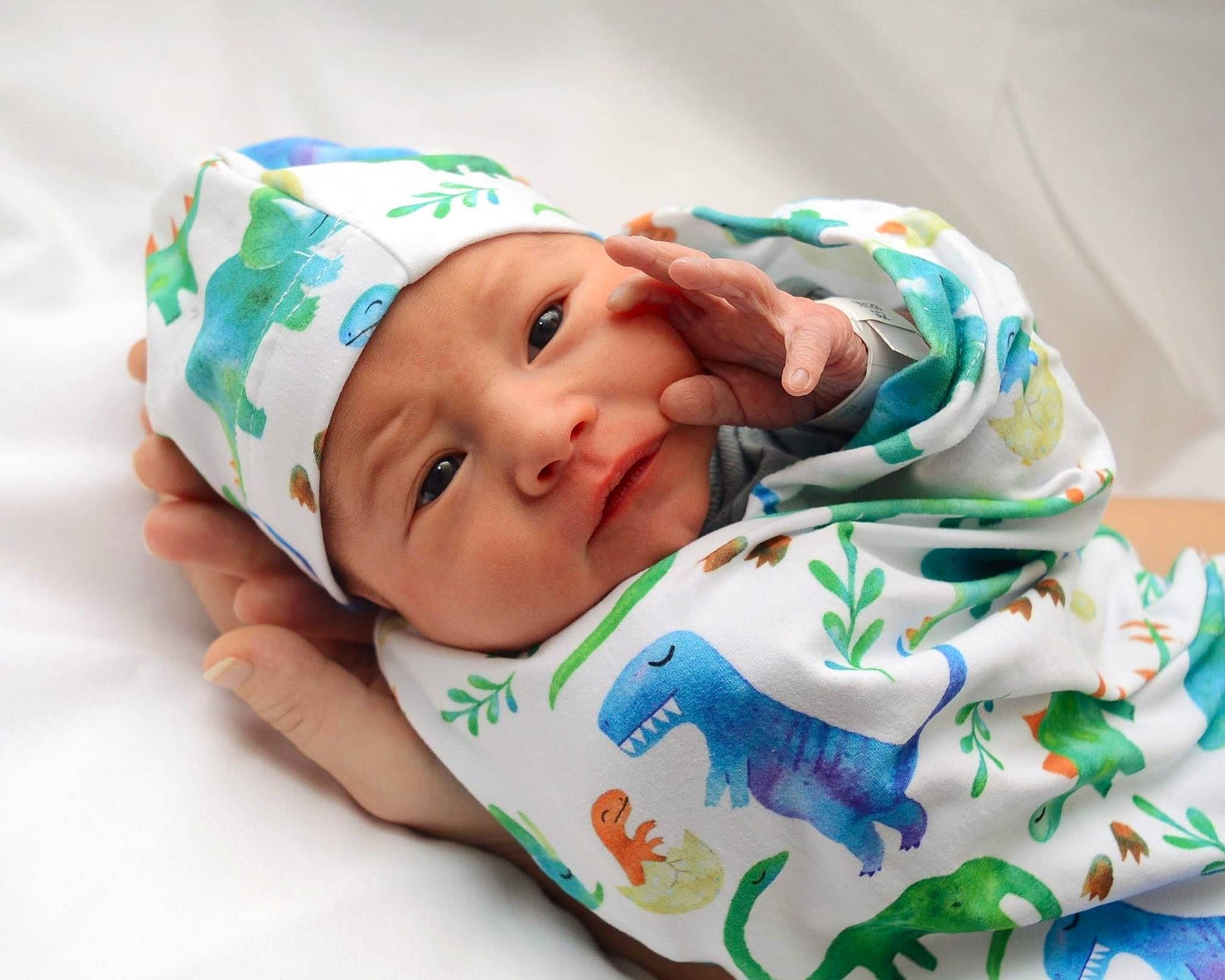 Jonas is registered to the contest to win money with this photo: baby, baby_products, baby_toddler_clothing, child, comfort, fashion_accessory, happy, hat, headwear, linens, pattern, person, room, service, sleeve, smile, textile, toddler