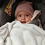 baby, infant, car_seat, beanie, hat, blanket, cozy, portrait, close_up, eyes, face, cheeks, hood, harness, airbag_label, safety_label, winter_clothing, soft_texture, adorable, gaze