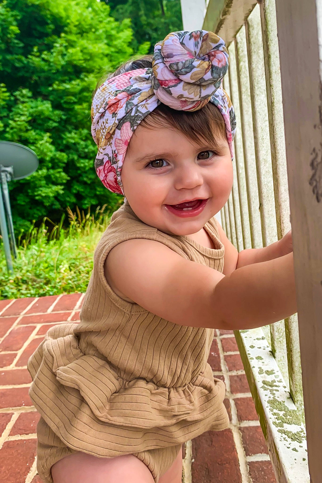 Analeigh is registered to the contest to win money with this photo: baby_toddler_clothing, cap, clothing, eye, face, facial_expression, fun, grass, green, happy, headpiece, headwear, human_body, joy, leisure, person, pink, plant, recreation, smile