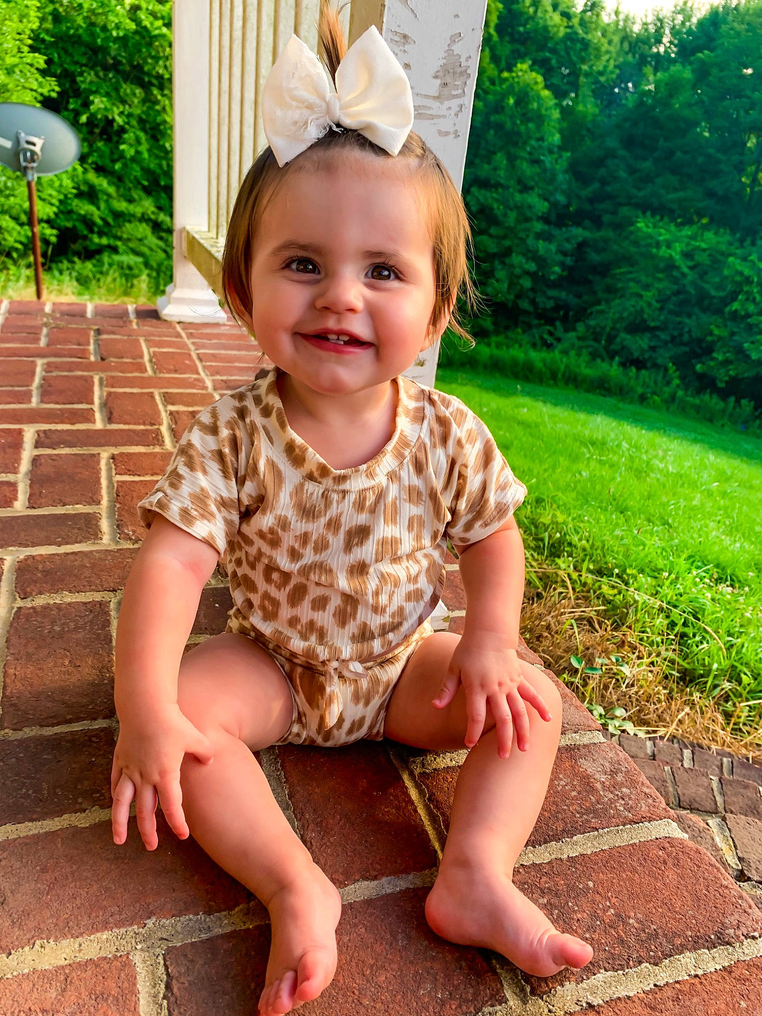 Analeigh is registered to the contest to win money with this photo: baby_toddler_clothing, child, clothing, dress, eye, face, grass, green, happy, head, human_body, joy, leaf, person, pink, plant, skin, sleeve, smile, summer