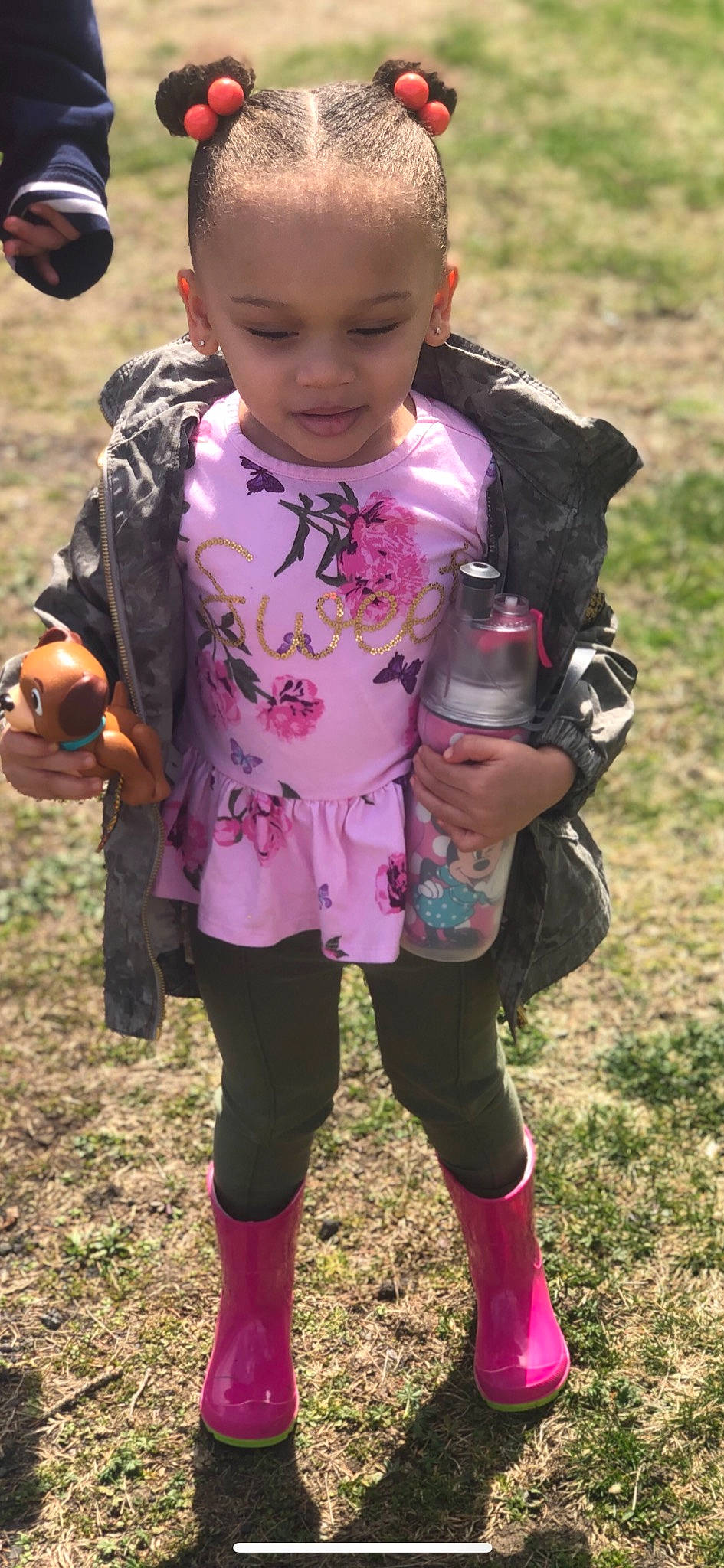 Gizelle is registered to the contest to win money with this photo: child, grass, person, personal_protective_equipment, pink, plant, play, smile, toddler