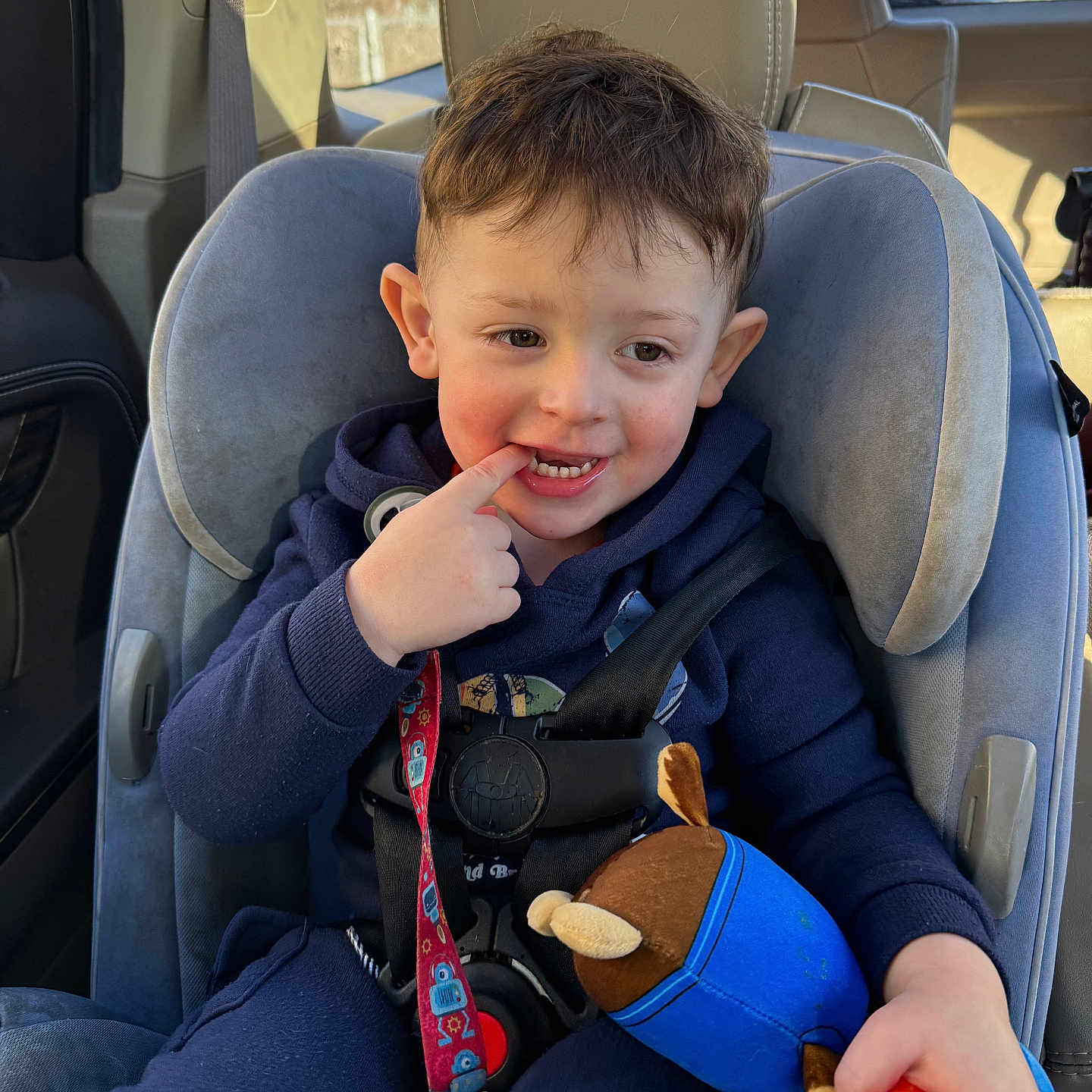 Kai is registered to the contest to win money with this photo: baby, bodypart, car, car_interior, carseat, chair, cushion, face, finger, food, furniture, hand, head, homedecor, person, photography, portrait, toy, transportation, vehicle