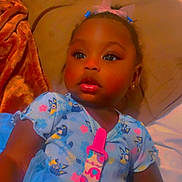 Miracle joined the competition — help win amazing prizes! toddler, child, baby, blue_dress, pacifier_clip, bed, blanket, curly_hair, earrings, cute, indoor, portrait, relaxed, sleepwear, soft_toys, colorful, smiling, face, person, young