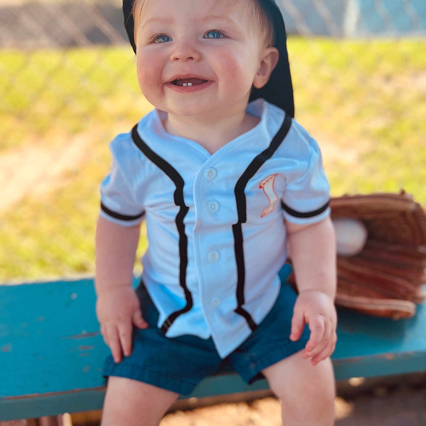 Gabriel is registered to the contest to win money with this photo: baby, baseball, baseballcap, baseballglove, bench, cap, clothing, face, footwear, furniture, glove, hat, head, people, person, photography, portrait, shoe, shorts, sport