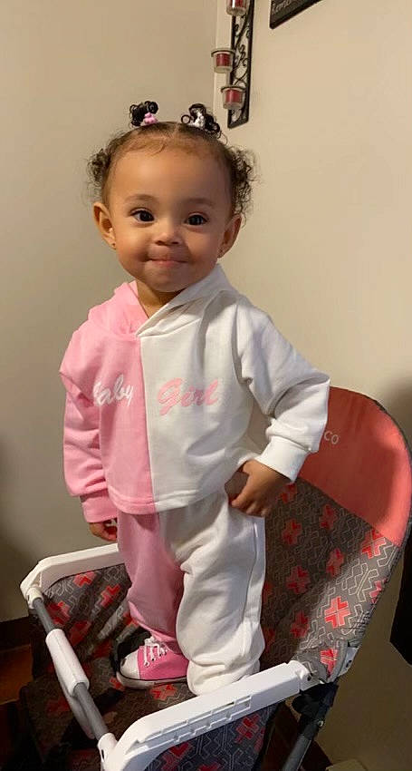 Royalty is registered to the contest to win money with this photo: baby_toddler_clothing, cheek, child, dress, dress_shirt, fashion_design, formal_wear, fun, hairstyle, happy, joy, pattern, person, pink, shoulder, sitting, skin, sleeve, smile, sock