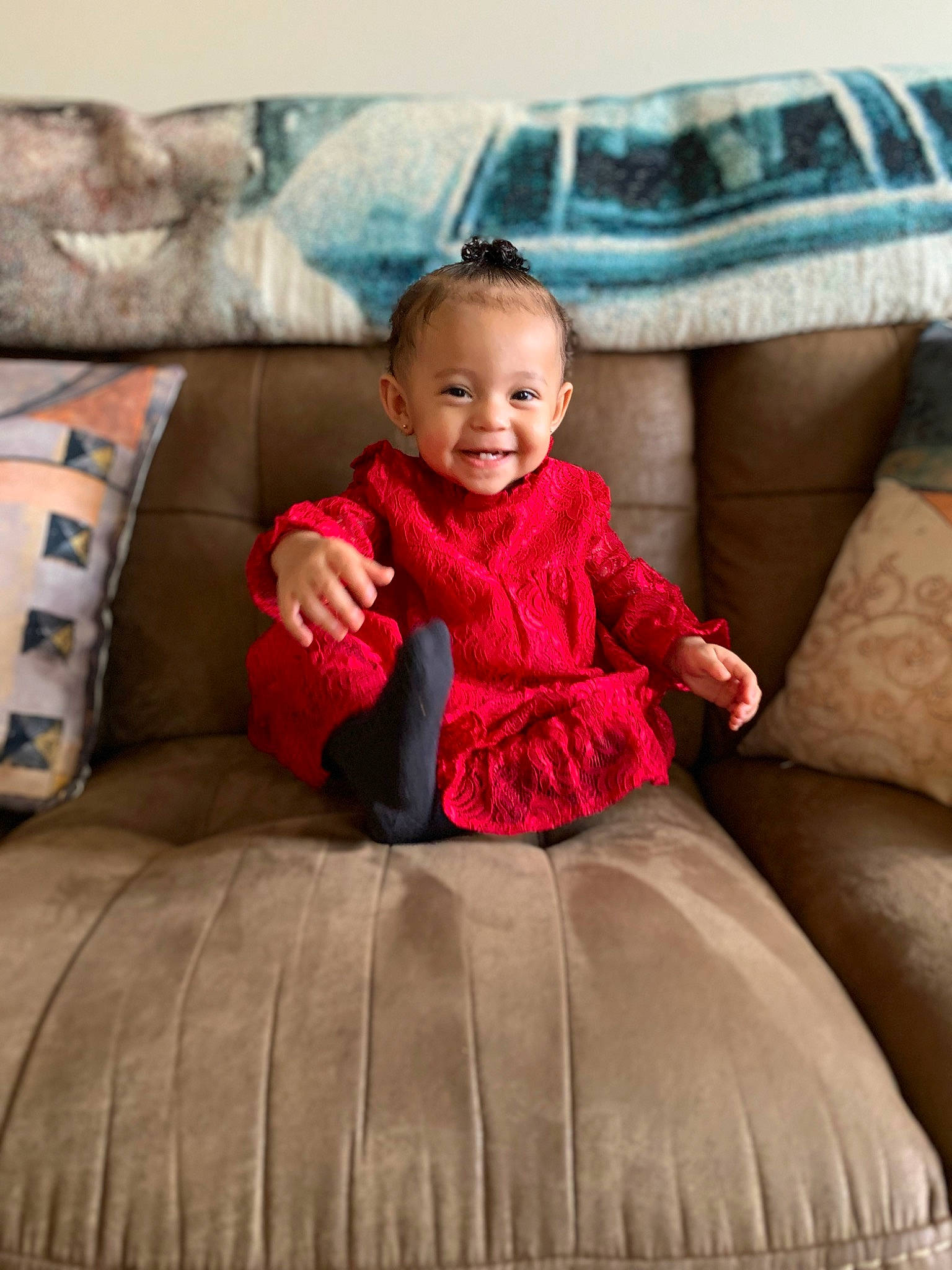 Royalty is registered to the contest to win money with this photo: baby, baby_toddler_clothing, child, comfort, couch, dress, face, flooring, fun, furniture, happy, joy, living_room, magenta, person, pillow, pink, product, sitting, sleeve