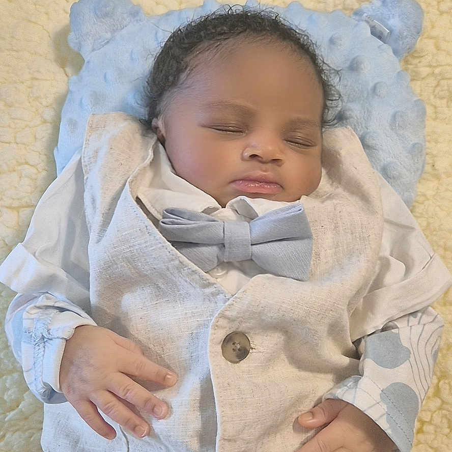 Nasri participe au concours pour gagner de l'argent avec cette photo : baby, blanket, bow_tie, boy, child, clothing, cute, face, hand, indoors, infant, newborn, peaceful, pillow, portrait, rest, sleeping, soft_texture, suit, vest