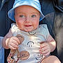 Bentley is registered to the contest to win money with this photo: baby, child, smiling, blue_hat, onesie, pacifier, stroller, infant, cute, happy, outdoor, sunlight, hands, face, eyes, cheeks, clothing, sitting, toy, closeup