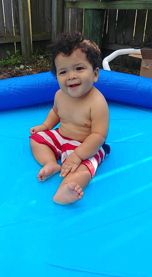 Mono is registered to the contest to win money with this photo: baby, blue, child, fun, games, inflatable, joy, leisure, person, play, pool, product, recreation, skin, smile, summer, swimming_pool, toddler, vacation, water_park