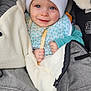 baby, child, smiling, hat, white_hat, blanket, stroller, blue_eyes, holding, wooden_stick, clothing, bundle, warm, face, infant, cute, portrait, cozy, closeup, baby_boy