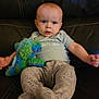 Corsen joined the competition — help win amazing prizes! baby, infant, child, plush_toy, stuffed_animal, couch, leather, clothing, sitting, expression, face, head, person, comfort, indoor, pajamas, footwear, blue, green, cute