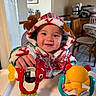 Lukas is registered to the contest to win money with this photo: baby, chair, child, colorful, cozy, cute, face, festive_clothing, hand, high_chair, home, hoodie, indoor, person, playful, reindeer, smiling, table, toys, wooden_furniture