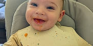 Alexander joined the competition — help win amazing prizes! baby, smiling, bib, high_chair, food, face, infant, messy, happy, child, indoor, furniture, person, cute, feeding, young_child, clothing, home, seat, portrait