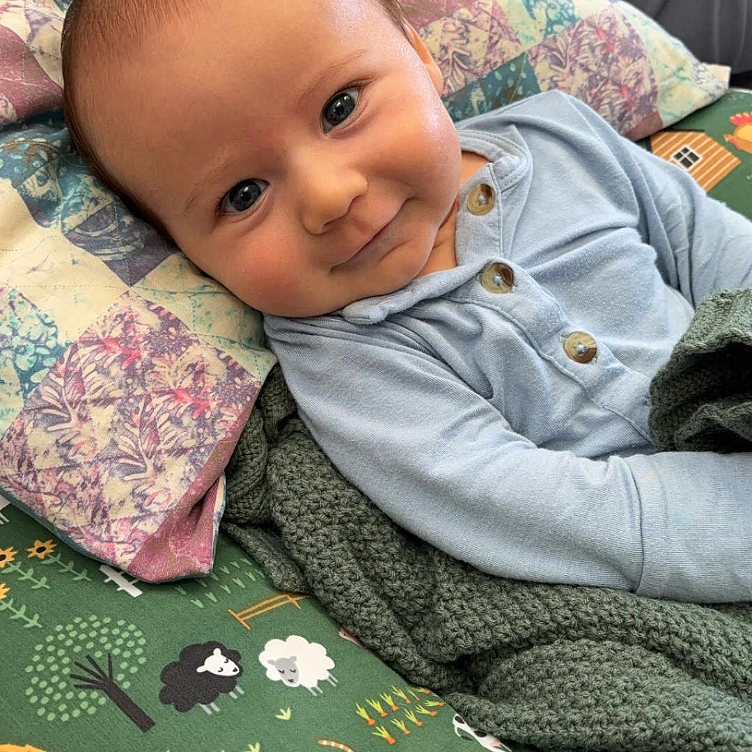 Luke joined the competition — help win amazing prizes! animal, baby, bed, bird, blanket, clothing, couch, cushion, face, furniture, happy, head, homedecor, linen, pants, person, photography, portrait, quilt, smile